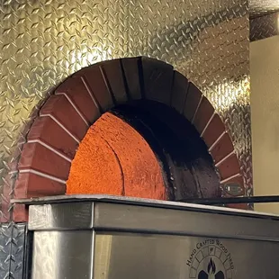 That's a real wood burning oven  that I believe the owner actually splits himself