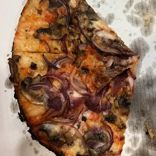 a slice of pizza with onions on it
