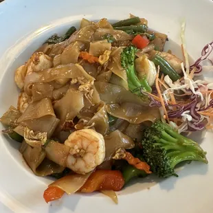 a plate of stir fried vegetables and shrimp