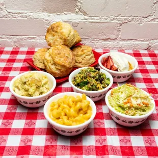 four bowls of food on a checkered tablecloth