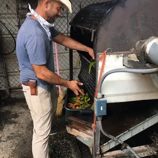 a man in a cowboy hat cooking