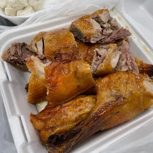 a variety of meats in a styrofoam container