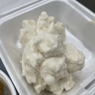 a container of ice cream and a bowl of macaroni and cheese