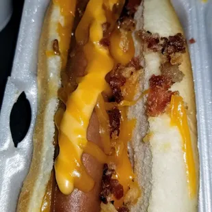Loaded dog. Chili, cheese, potato puff, bacon, crispy onions