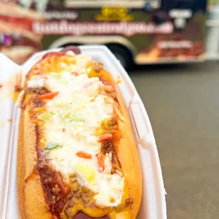 a hot dog with cheese and ketchup