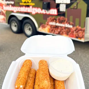 a person holding a container of food