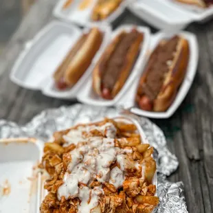 a plate of pulled pork and cheese hotdogs