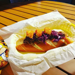 Mardi Gras Special Sabrearak Hot Dog- Pleasant combo of pulled pork, cabbage, and tater tots!