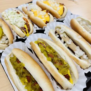 four hot dogs with relish and mustard