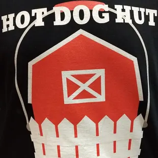 a red barn and a white fence