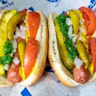 two hot dogs with toppings