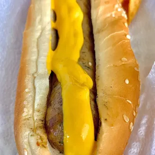 a hot dog with cheese and mustard