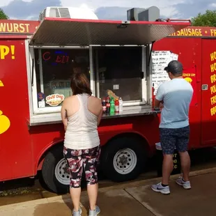 two people ordering food from a food truck