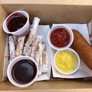 Funnel Cake Sticks w/ chocolate and raspberry sauces, and beef corndog with ketchup and mustard