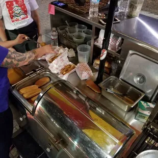 a woman serving hot dogs