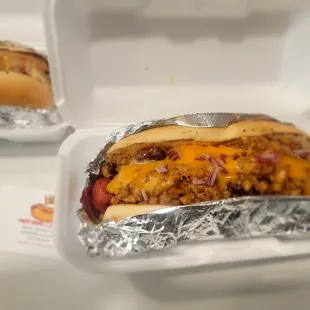 two hot dogs in a styrofoam container