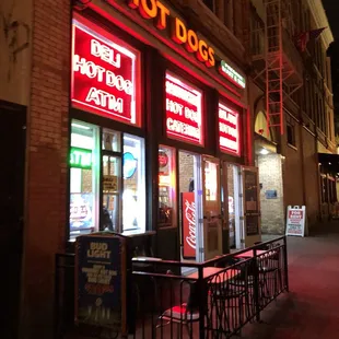 a neon sign for a hot dog shop