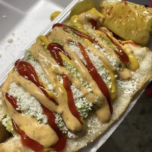 hot dog with condiments and extras from the hot rod