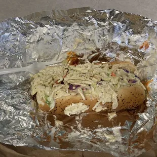 a hot dog with coleslaw and coleslaw slaw