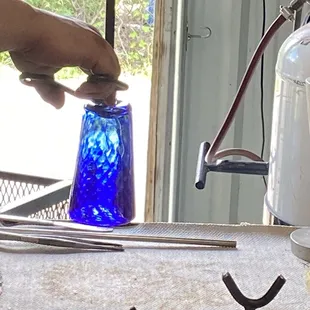 Glass artist finishes our pint glass