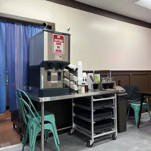 Self serve area--water, utensils, and to-go boxes