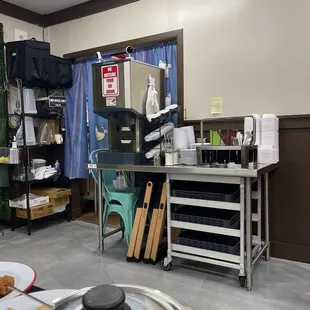 Self serve area with water, utensils and take out containers