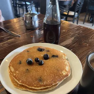 Blueberry pancakes with real butter and warm bottle of syrup