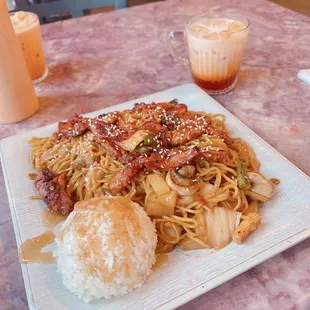 a plate of noodles and meat