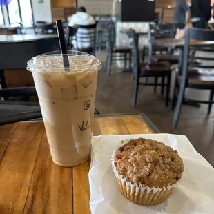 a cup of coffee and a muffin on a table