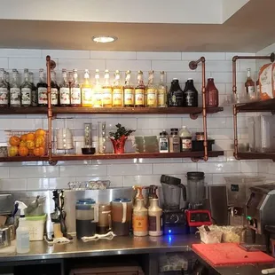 a kitchen with a lot of bottles on the shelves
