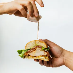 a person holding a sandwich