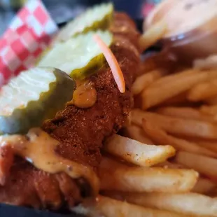 a basket of fries and a pickle