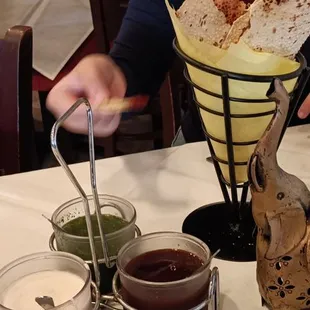 First thing when you sit down. They flat roasting bread with three different sauces. The atmosphere is awesome service is great.