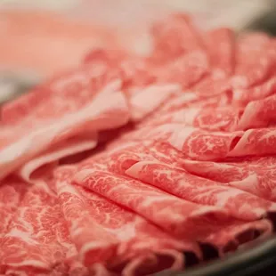 a close up of a hot pot of meat