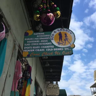 Store Sign with HUGE Mardi Gras beads hanging down!