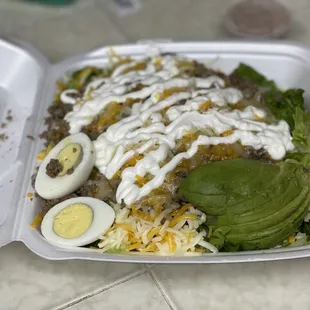 Taco Salad. Not sure why it has a hard boiled egg instead of tortilla chips? But tons of meat and look at the size of that avocado