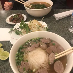 Front- Large meatball pho (P6) Back- Large spicy brisket pho (P2)
