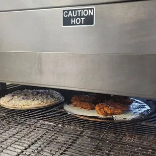 two plates of food on a grill