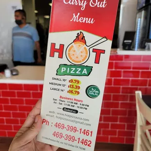 a hand holding a carry out menu
