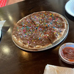 This is dessert, chocolate pizza and sprinkles! Come visit, I think you will really like it