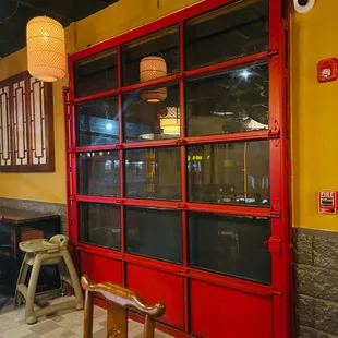 a bright red door and a yellow wall