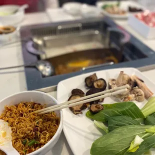 My mushrooms and bok Choy with some cooked instant noodles and the broths.