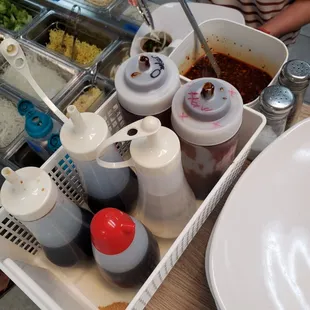 Sauces. Soy, sesame oil, oyster, vinegar. Don't know the others. The sauce with the spoon is