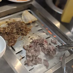 meat being cooked on a grill