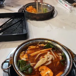 Hot pot ingredients put into the different broths.