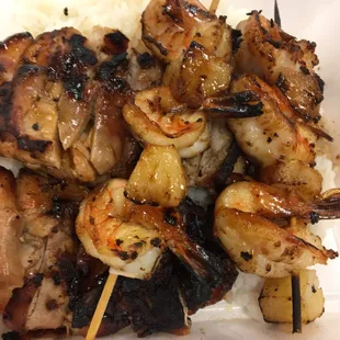Chicken teriyaki and shrimp skewers.