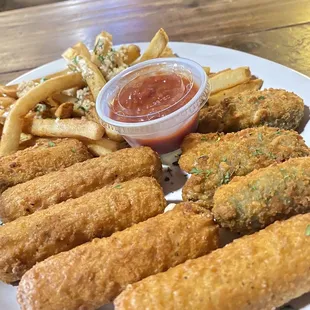 The trio plate garlic fries jalapeños poppers cheese sticks