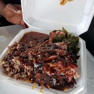 Combo meal featuring pulled pork, ribs, baked beans and greens. Soooo good!!