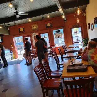 people sitting at tables in a restaurant