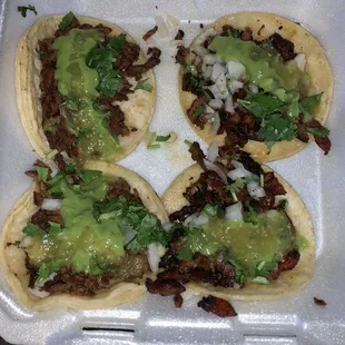 Carne Asada tacos with everything (cilantro, onion) and there is guacamole on top. So good!!